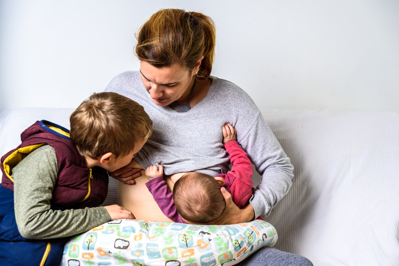 Mom Breastfeeding Two Sons in Tandem